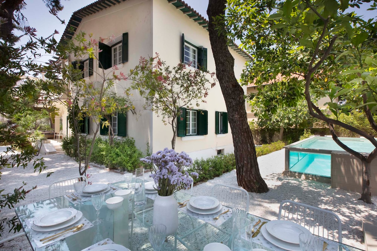 The 1950s Glyfada villa — garden table laid for dinner beside the private pool